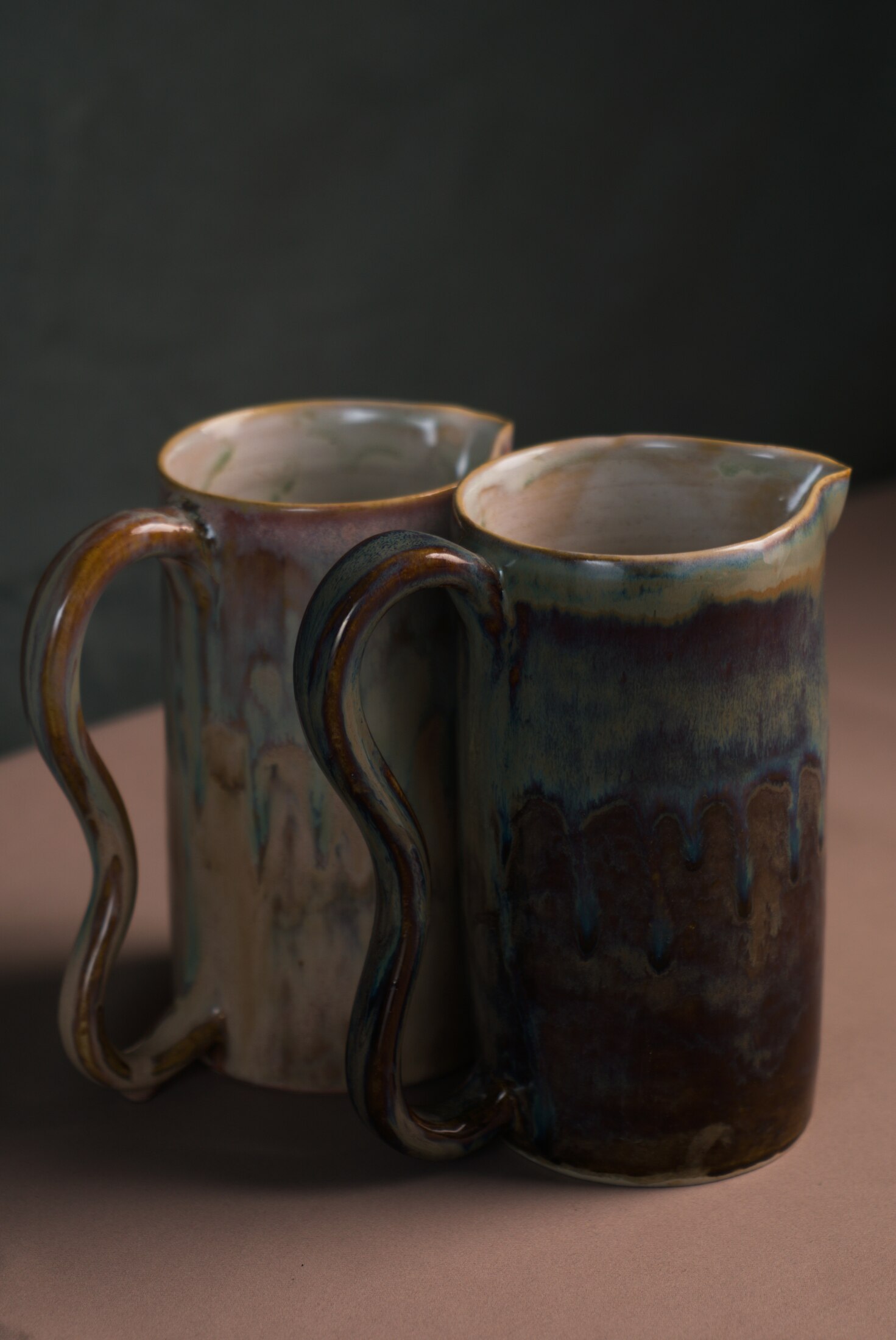 Pair of handled pitchers, glaze drips
