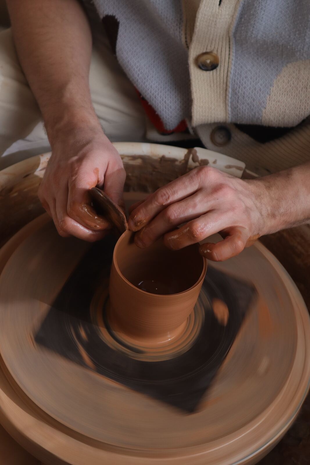 Demonstration on the wheel, throwing a red earthenware cup